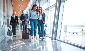 Female friends walking by window at airport.jpg