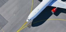 Aircraft on runway with yellow lines
