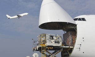 cargo-aircraft-loading-with-other-aircraft-taking-off.jpg