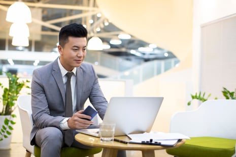 Businessman using laptop in office.jpg