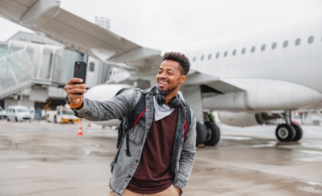 Passenger taking a selfie in front of aircraft.jpg