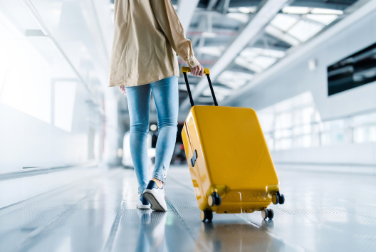 Passenger walking with luggage.png