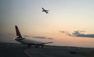 Aircraft crossing sky and ground.JPG