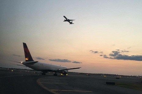 Aircraft crossing sky and ground.JPG