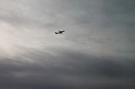 aircraft ascending in gray sky
